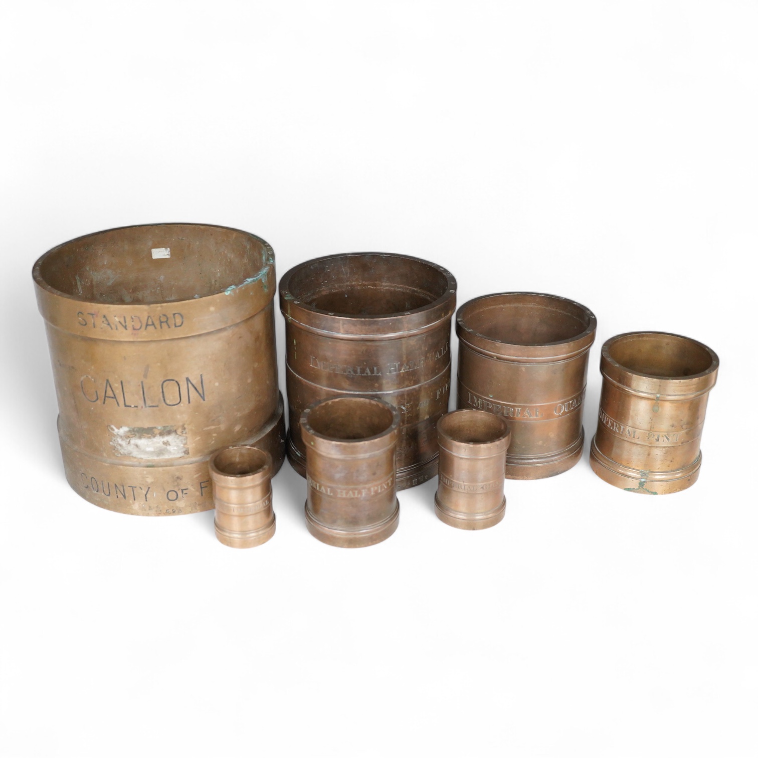 A set of seven early 20th century County of Fife official measures, comprising; a standard gallon, diameter 19.5cm, height 18.5cm, Imperial half gallon, Imperial quart, Imperial pint, Imperial half pint, Imperial gill, I